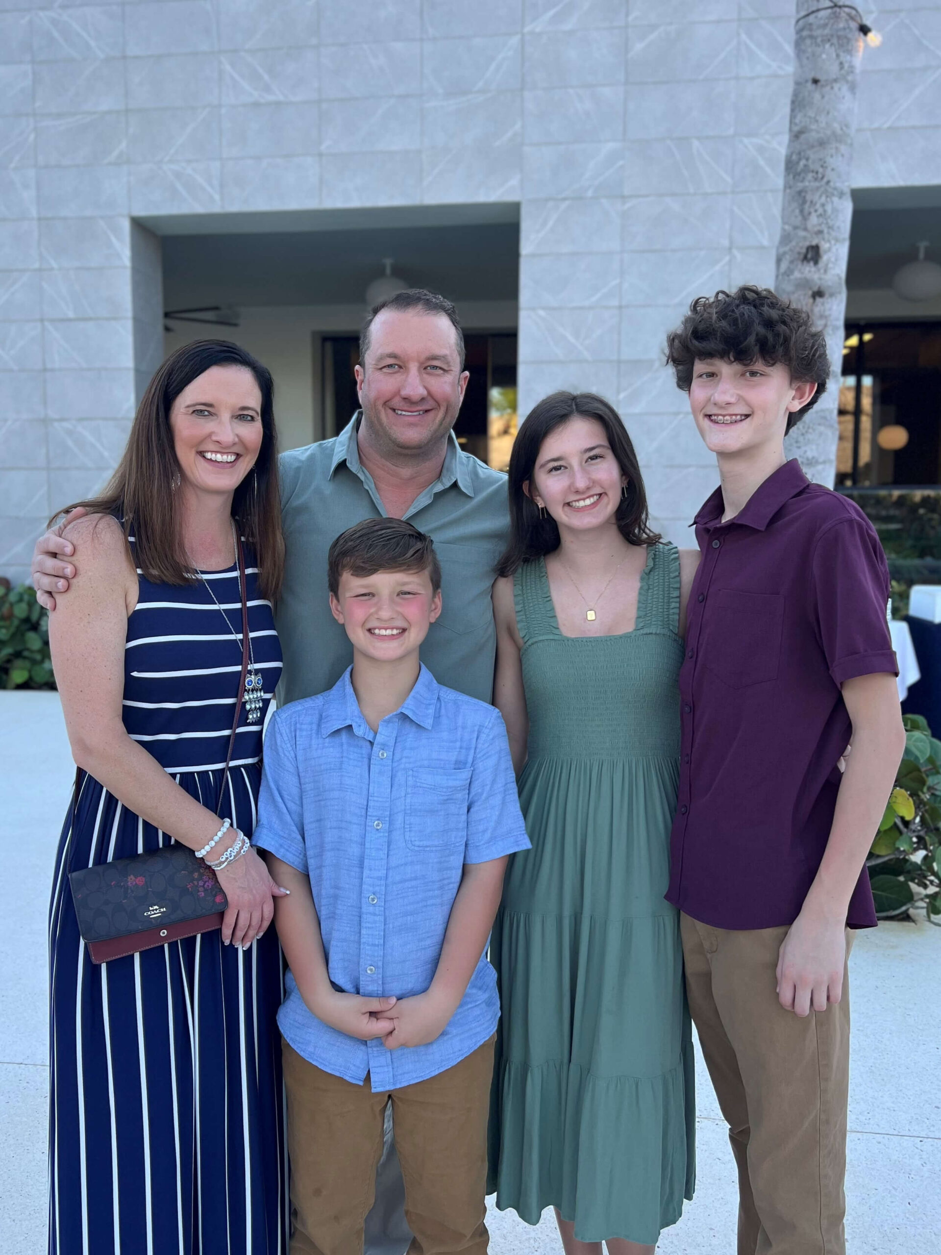 Troy and Heather Peterson with their three children posing together outdoors, showcasing family unity and community ties, relevant to THP Roofing's local and trustworthy service in Knoxville.